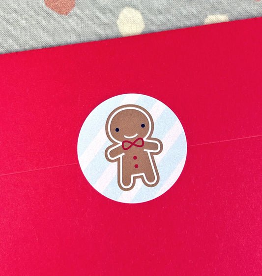 Close up of a red envelope sealed with a gingerbread man sticker