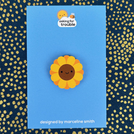 Brooches/pins are packaged on an illustrated backing card