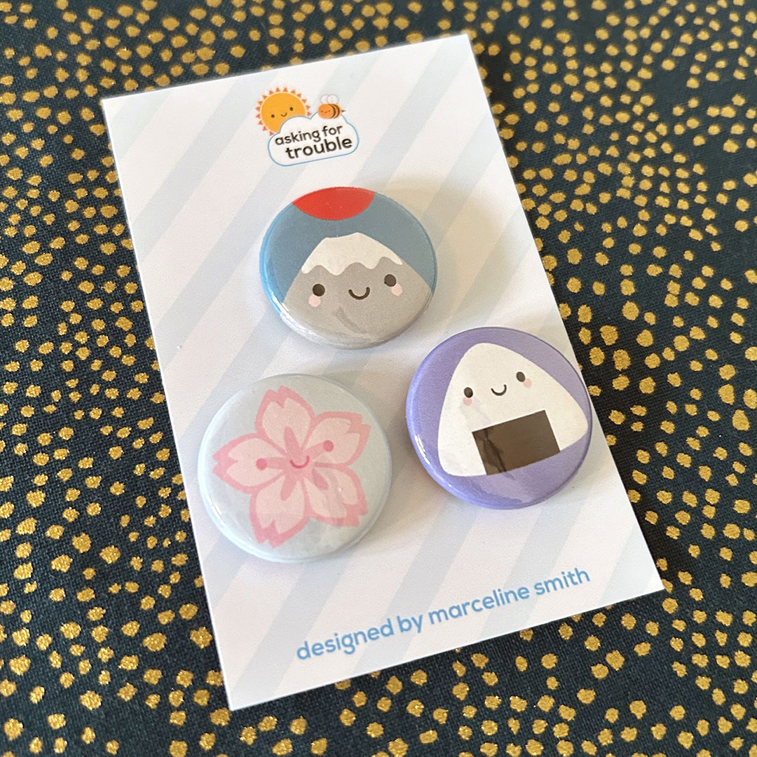 Badges are packaged on a striped backing card