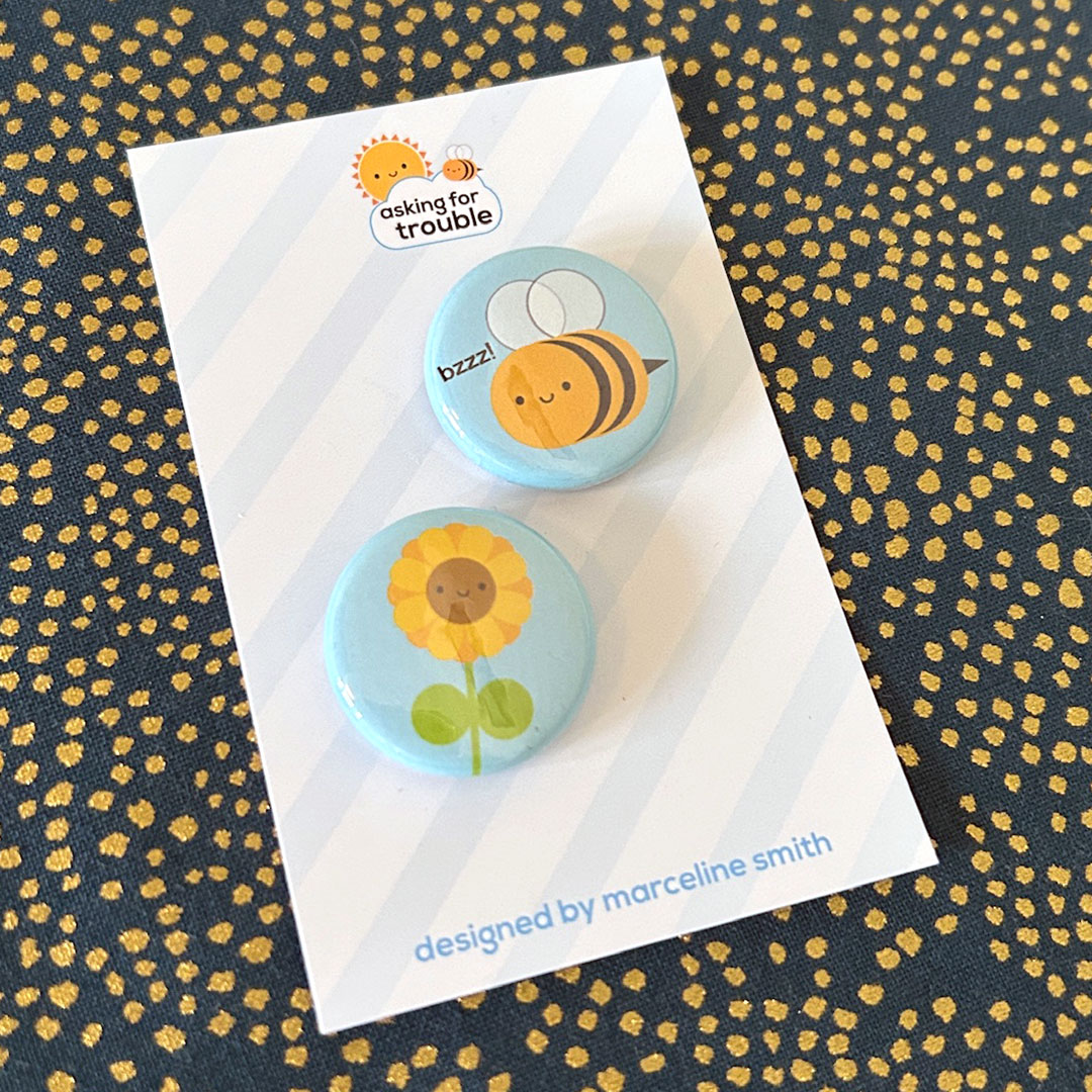 Badges are packaged on a striped backing card