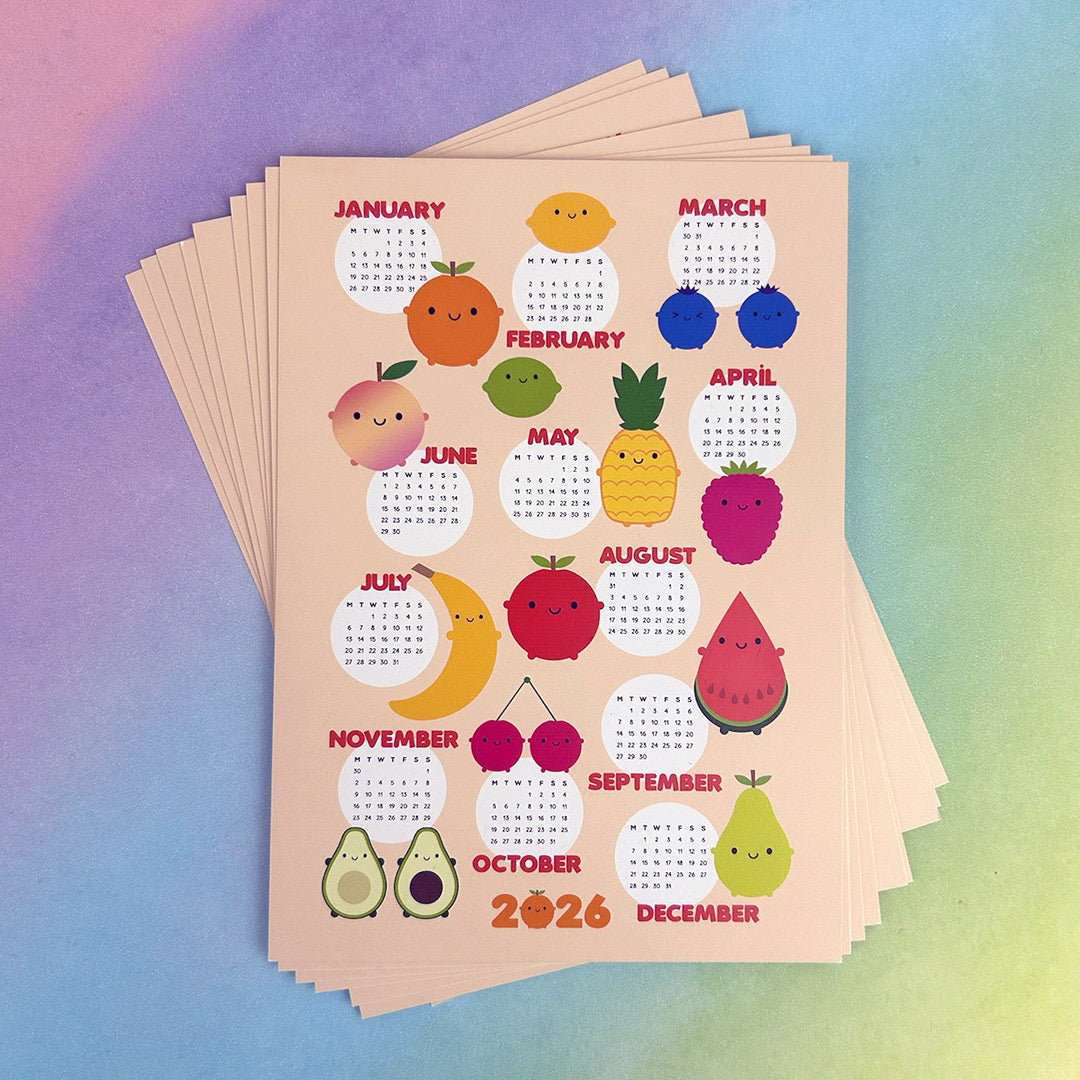 A stack of 2026 postcard calendars with fruit illustrations for each month on a colourful gradient background