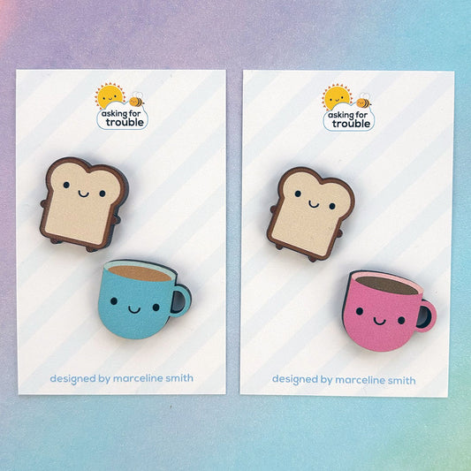 Brooches/pins are packaged on an illustrated backing card