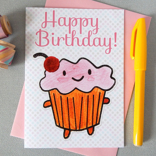 An illustrated card with a happy cupcake, the words 'happy birthday!' and a polka dot background