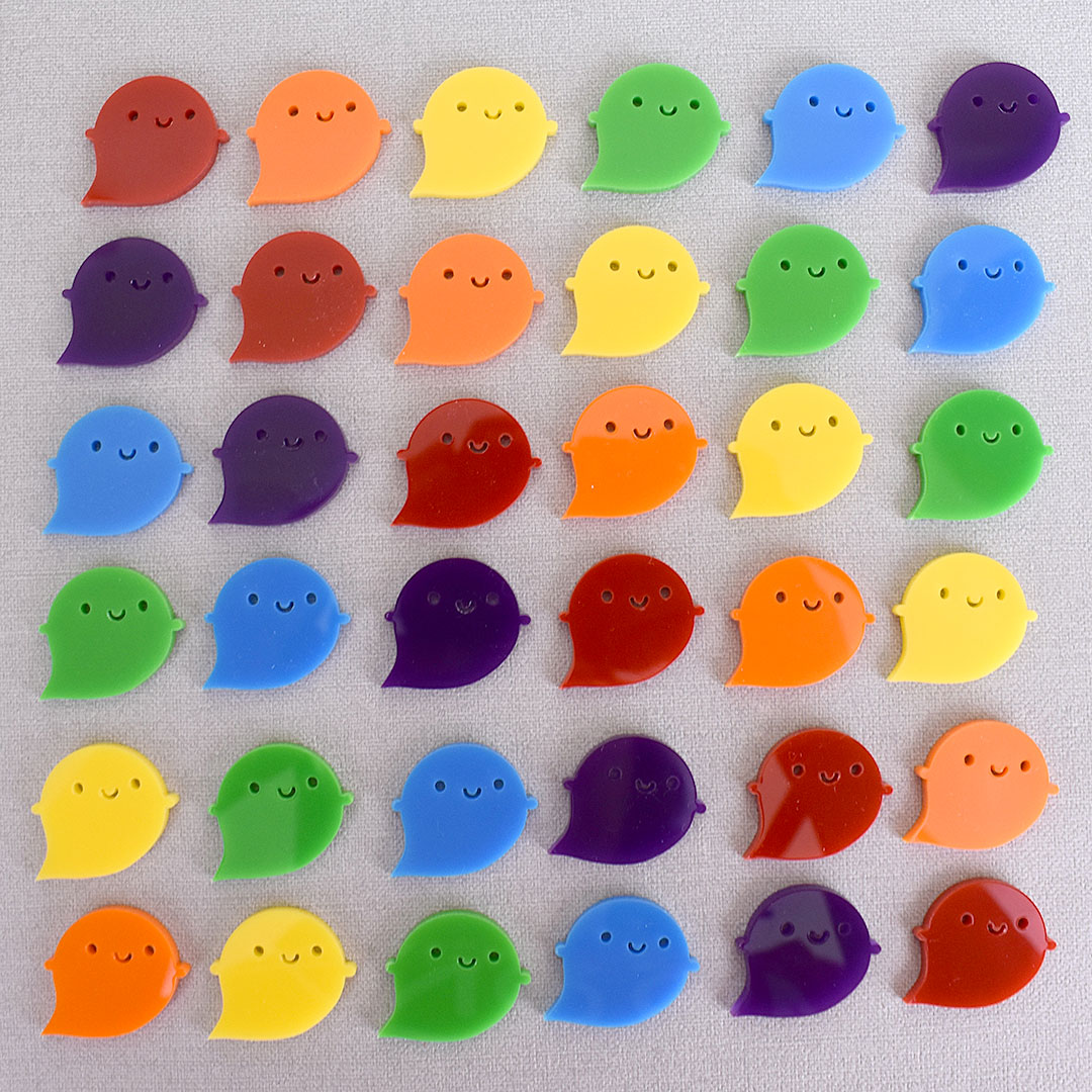 36 rainbow ghost brooches arranged in a pleasing striped square layout