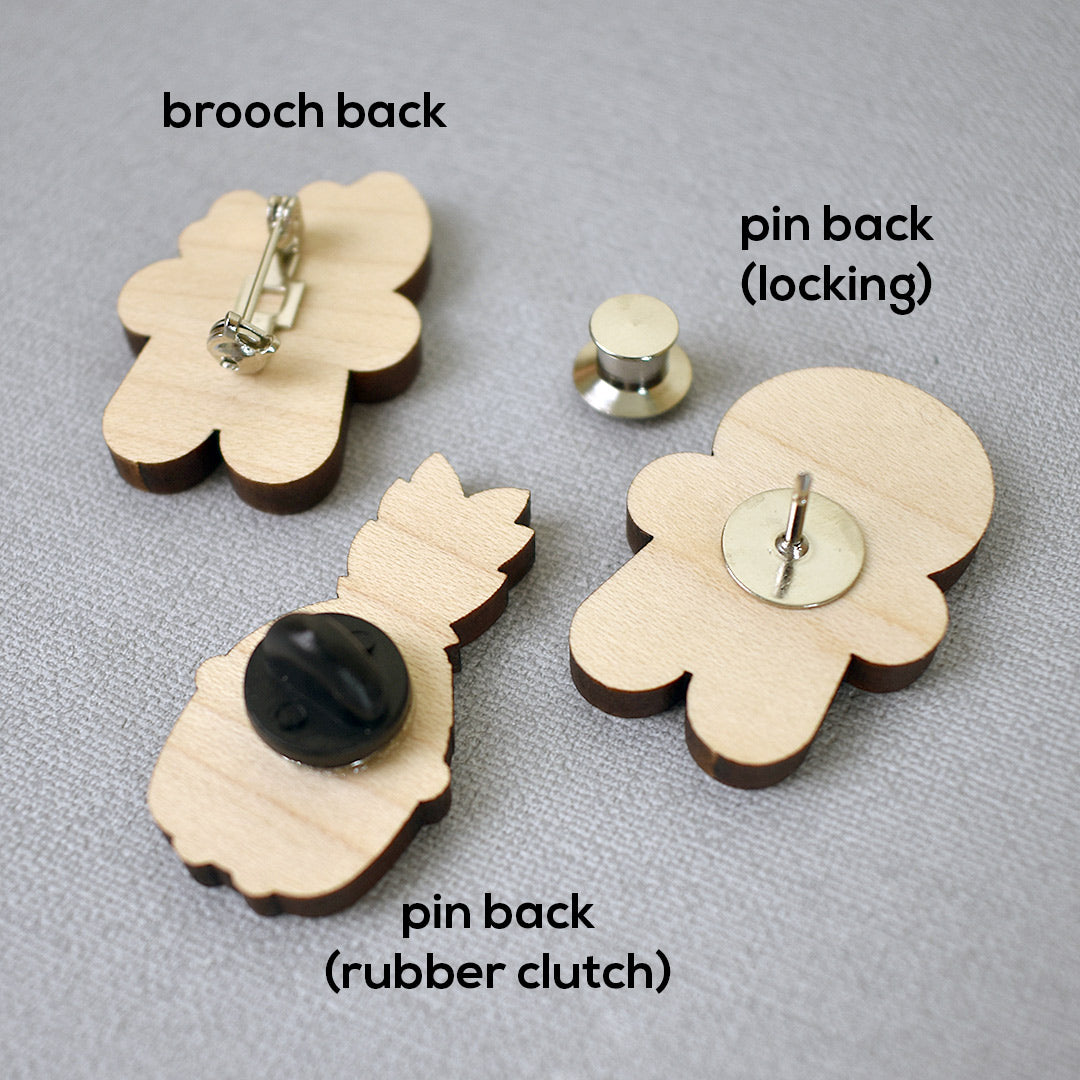 Examples of a brooch back, pin back, rubber clutch and locking back