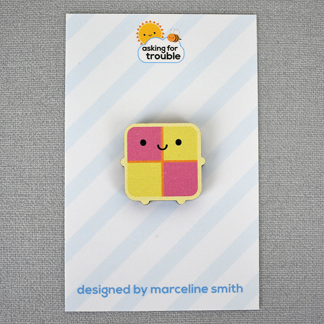 Brooches/pins are packaged on an illustrated backing card