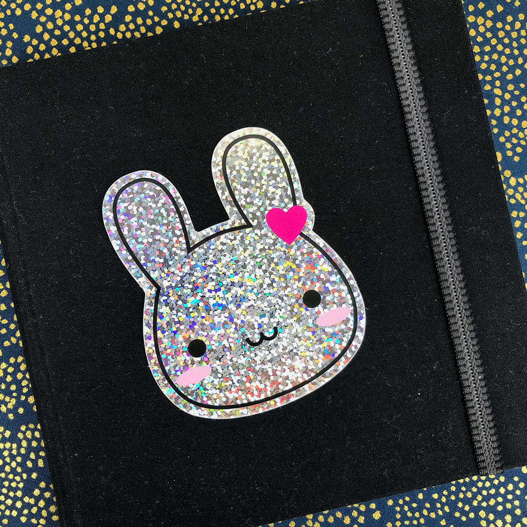 The vinyl sticker decorating a small sketchbook