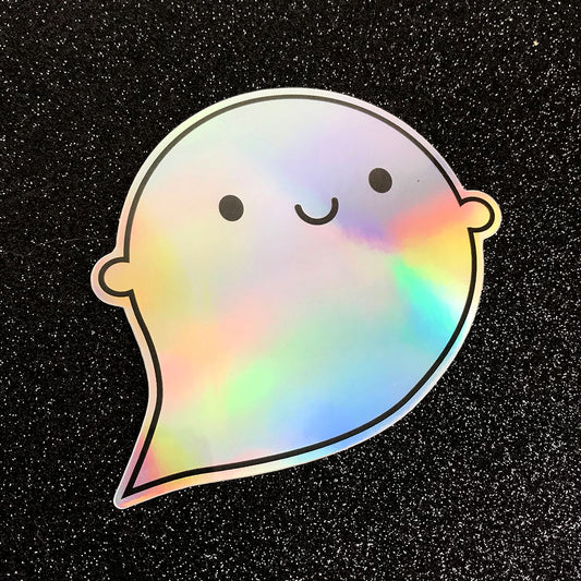 A die cut vinyl sticker of a happy ghost showing the colourful rainbow holographic foil