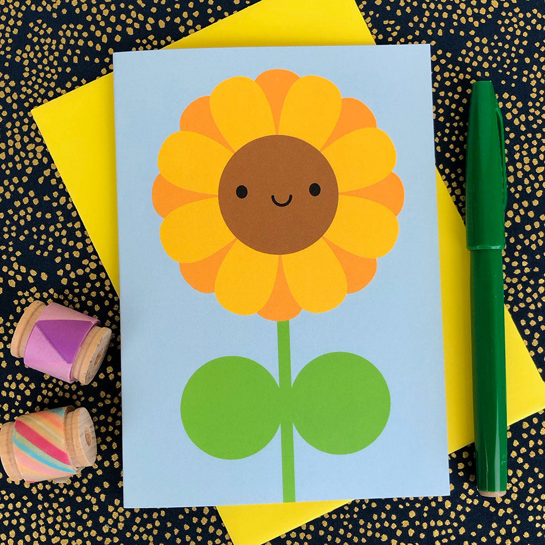An illustrated card with a happy Sunflower on a sky blue background