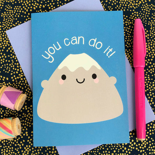 An illustrated card with a happy snow-topped mountain and the words 'you can do it!'