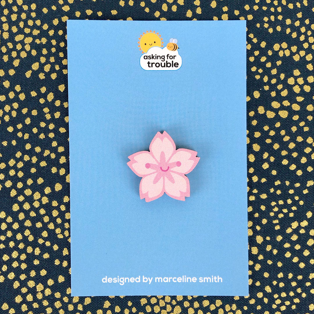 Brooches/pins are packaged on an illustrated backing card