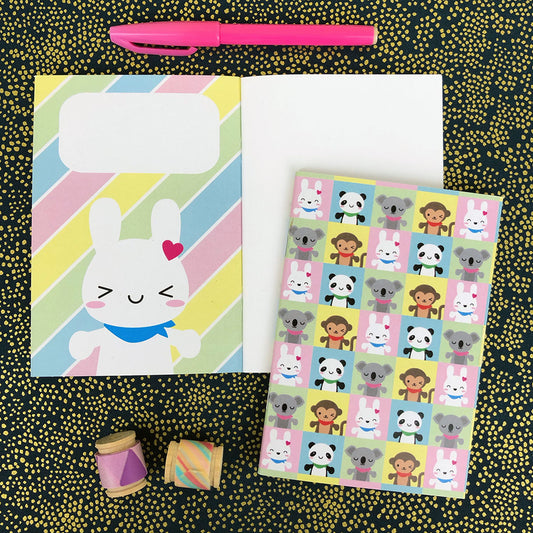 2 SCK mascots notebooks showing the patterned cover, the inside cover design with Bunny and the blank pages inside