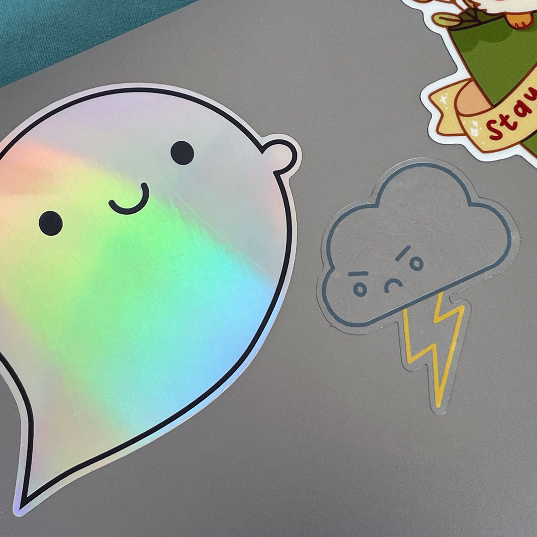 Holo Ghost and clear Thunder Cloud stickers on a laptop