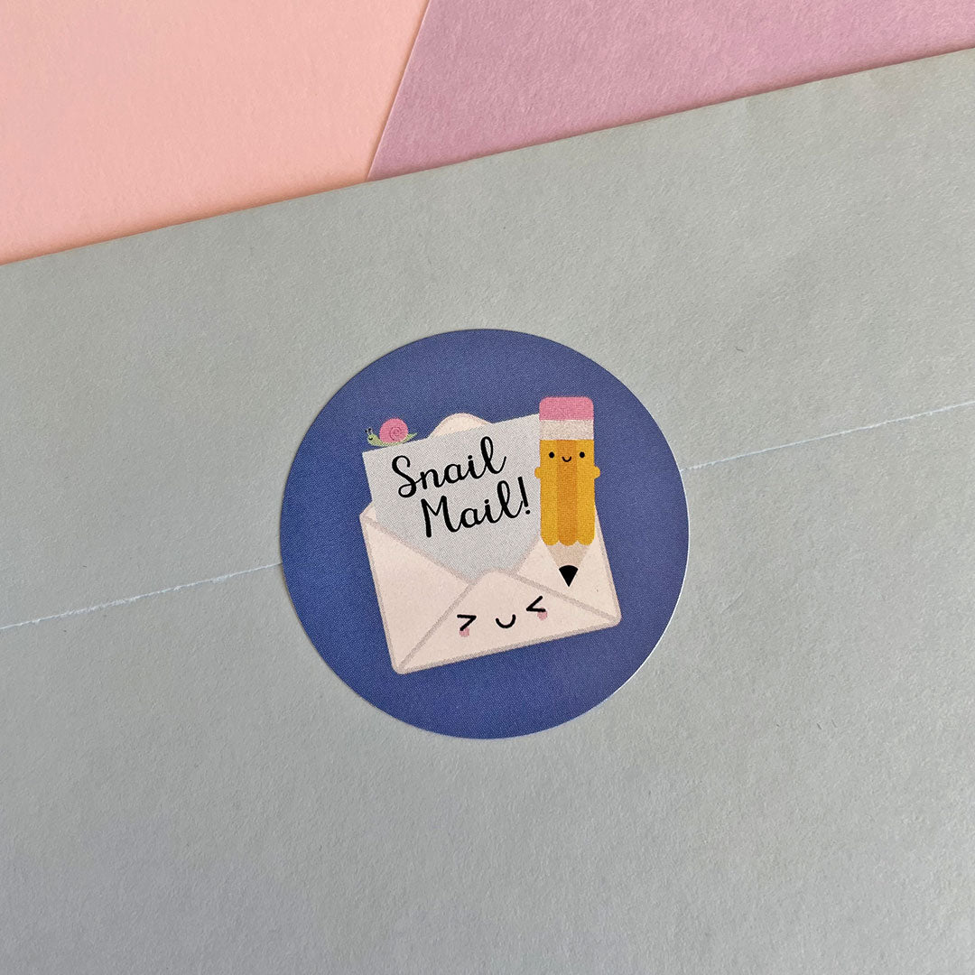 Close up of a Snail Mail sticker sealing a blue envelope