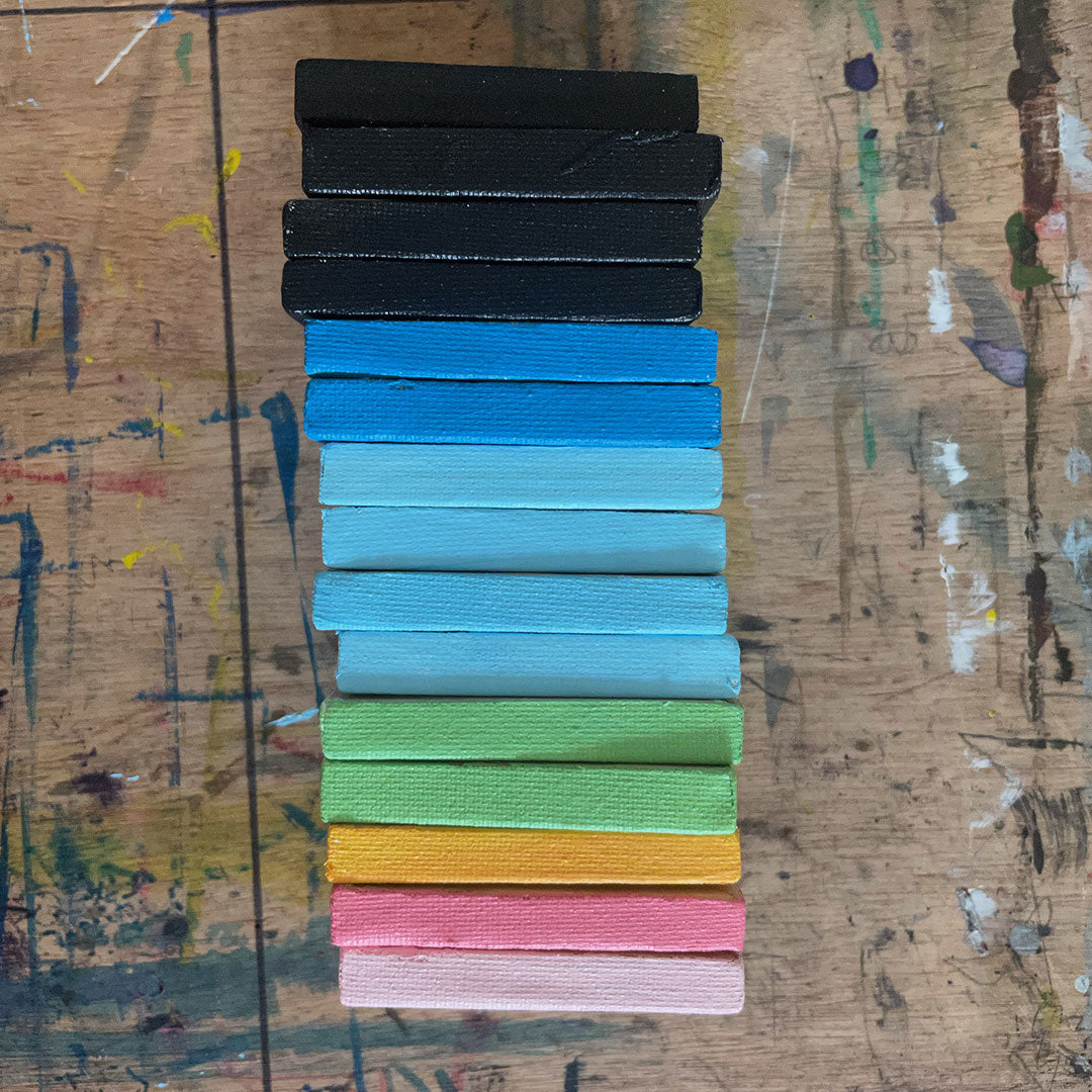 Stack of paintings showing the painted edges