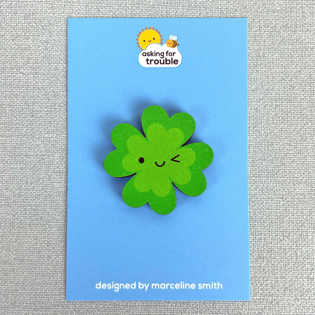 Brooches/pins are packaged on an illustrated backing card