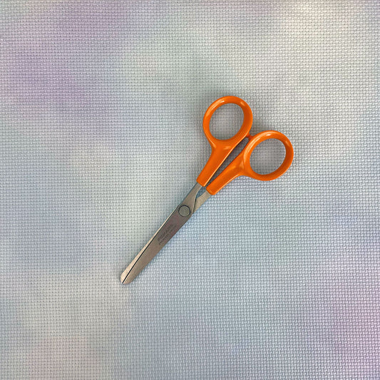 the aida with a pair of embroidery scissors for scale