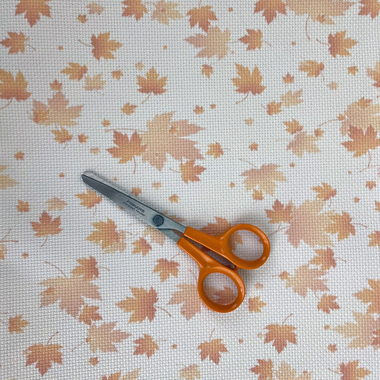 the aida with a pair of embroidery scissors for scale