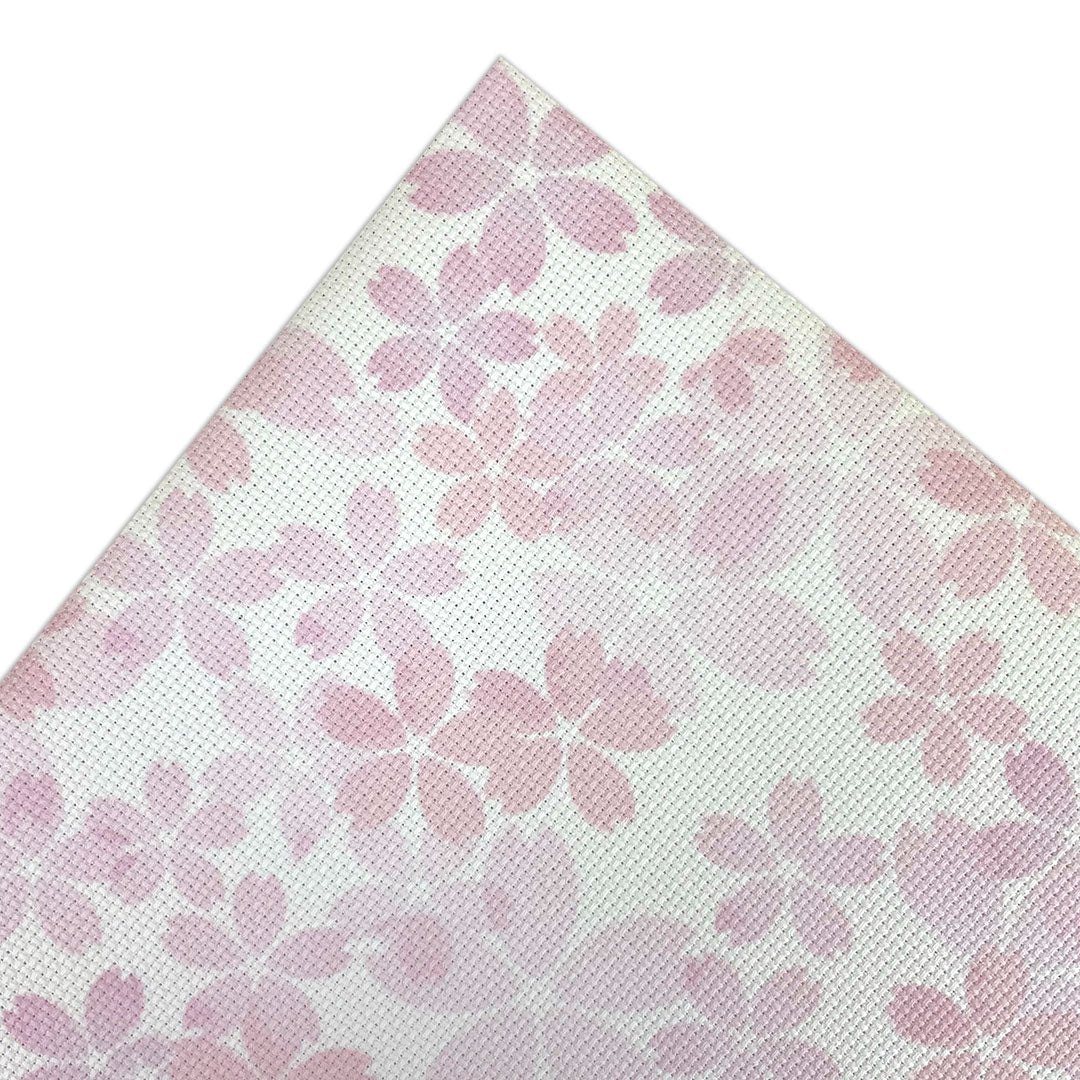 Aida fabric digitally printed with cherry blossoms and petals on a white background