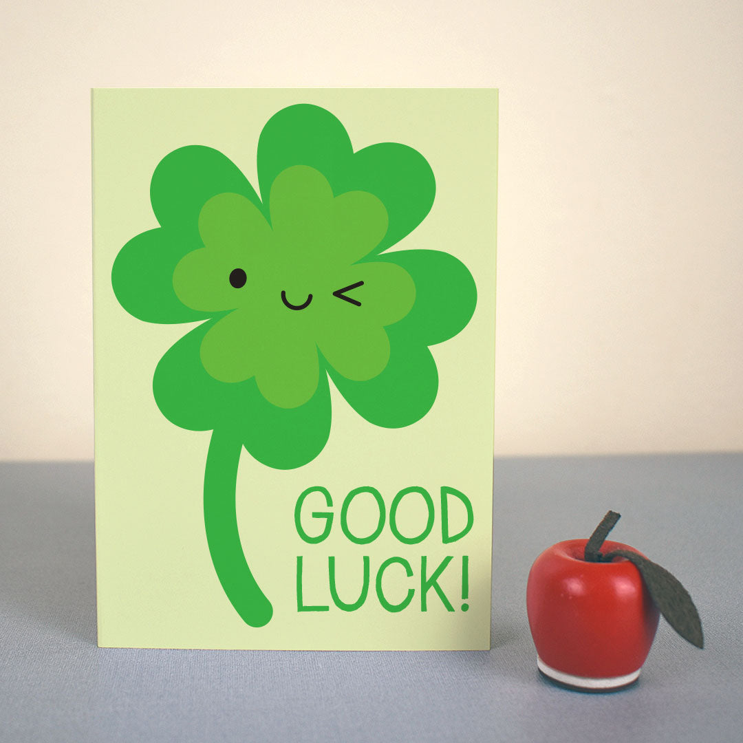 The card standing up with a small apple figure