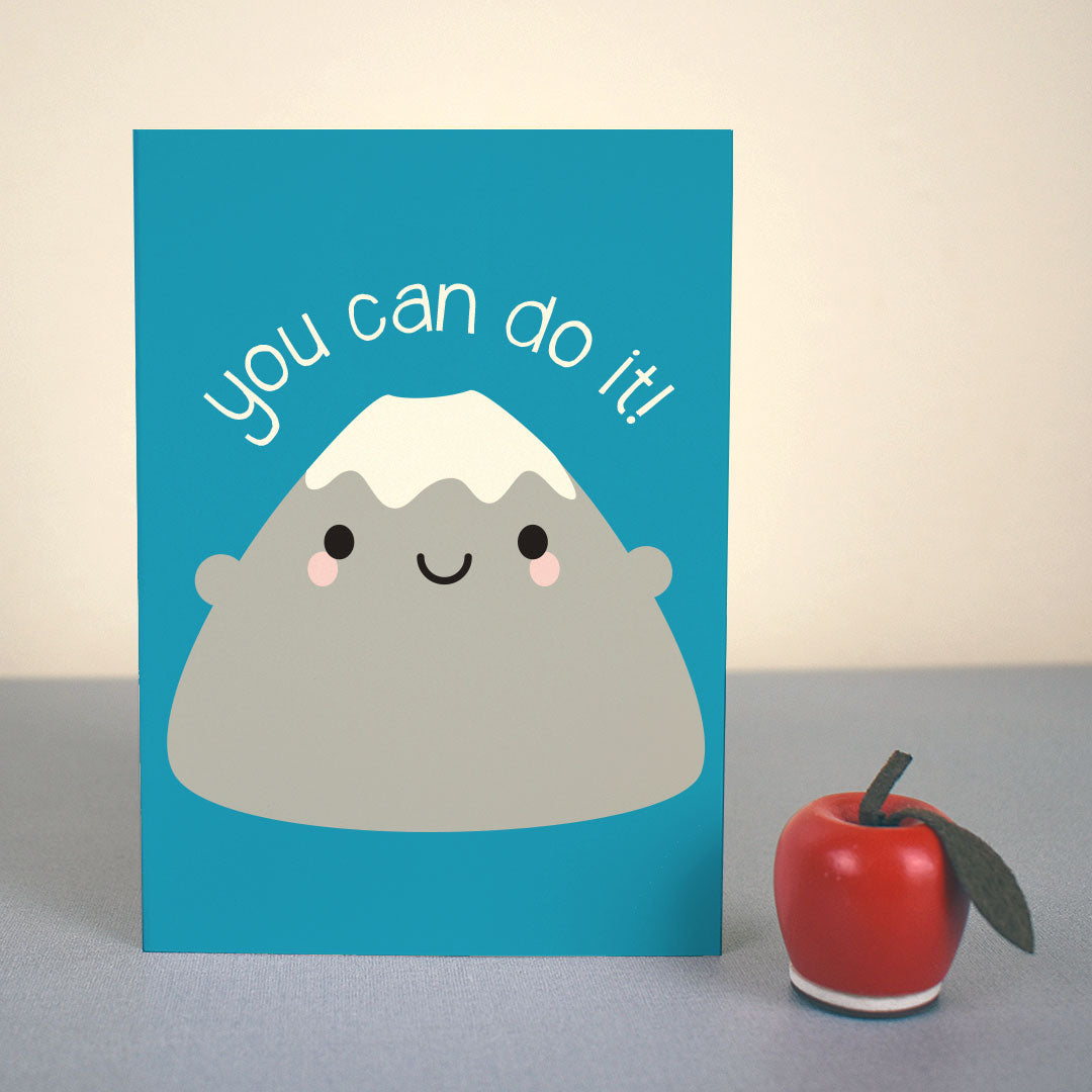 The card standing up with a small apple figure