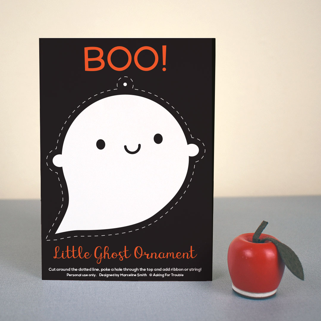 The postcard standing up with a small apple figure