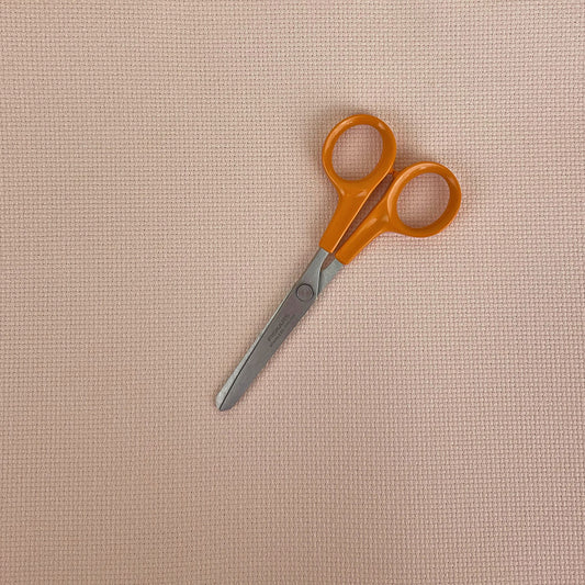 the aida with a pair of embroidery scissors for scale