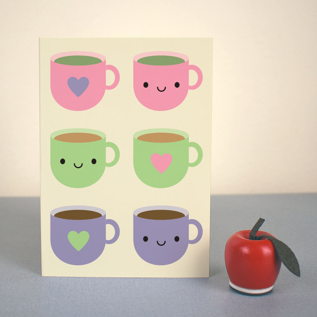 The card standing up with a small apple figure