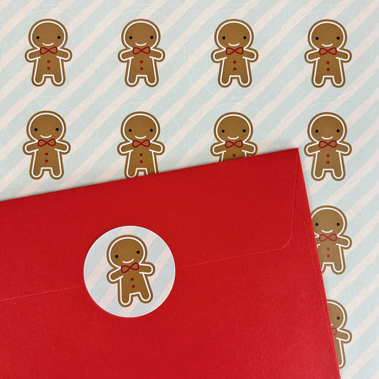 A sheet of gingerbread man stickers and one decorating an envelope