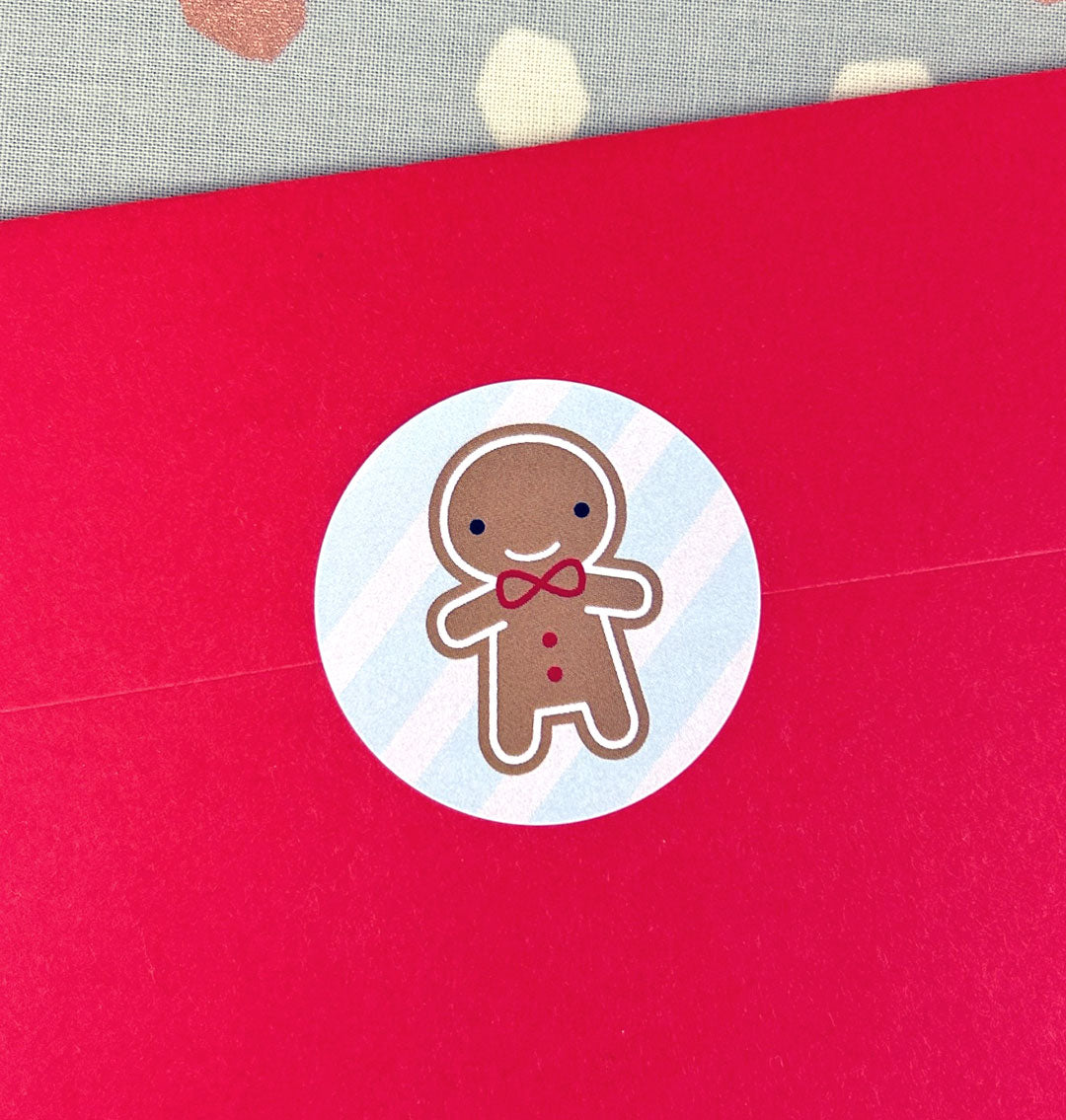 Close up of a red envelope sealed with a gingerbread man sticker