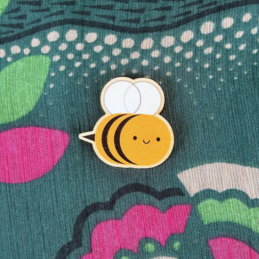 A happy kawaii Bumblebee pin made from ethically sourced, FSC certified wood