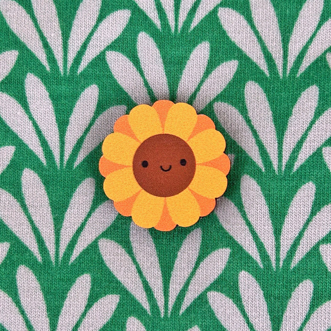 A happy kawaii Sunflower pin made from ethically sourced, FSC certified wood