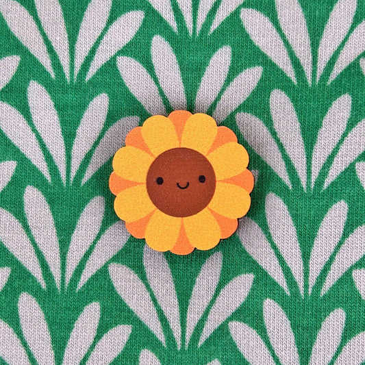 A happy kawaii Sunflower pin made from ethically sourced, FSC certified wood