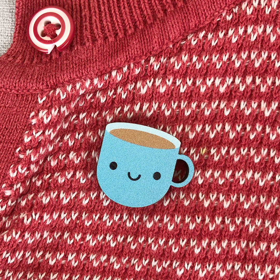 A blue happy kawaii Cup of Tea brooches made from ethically sourced, FSC certified wood