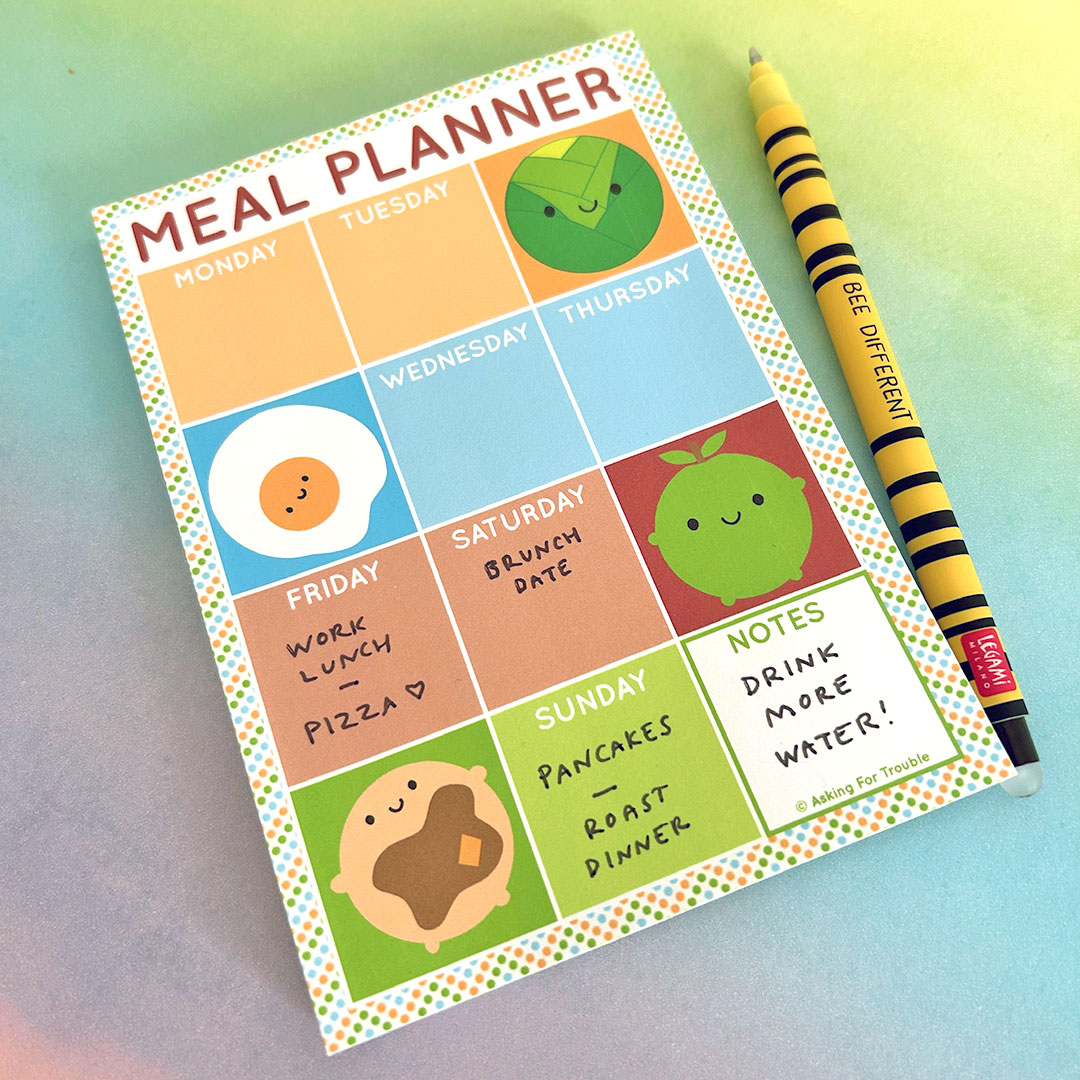 Example of meal planner notepad in use with hand-written notes and pen for scale