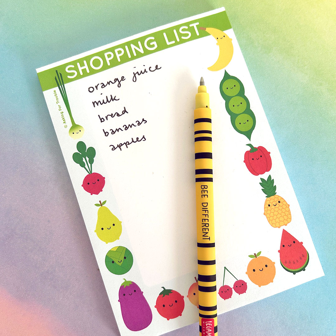 Shopping list notepad with a handwritten list and pen