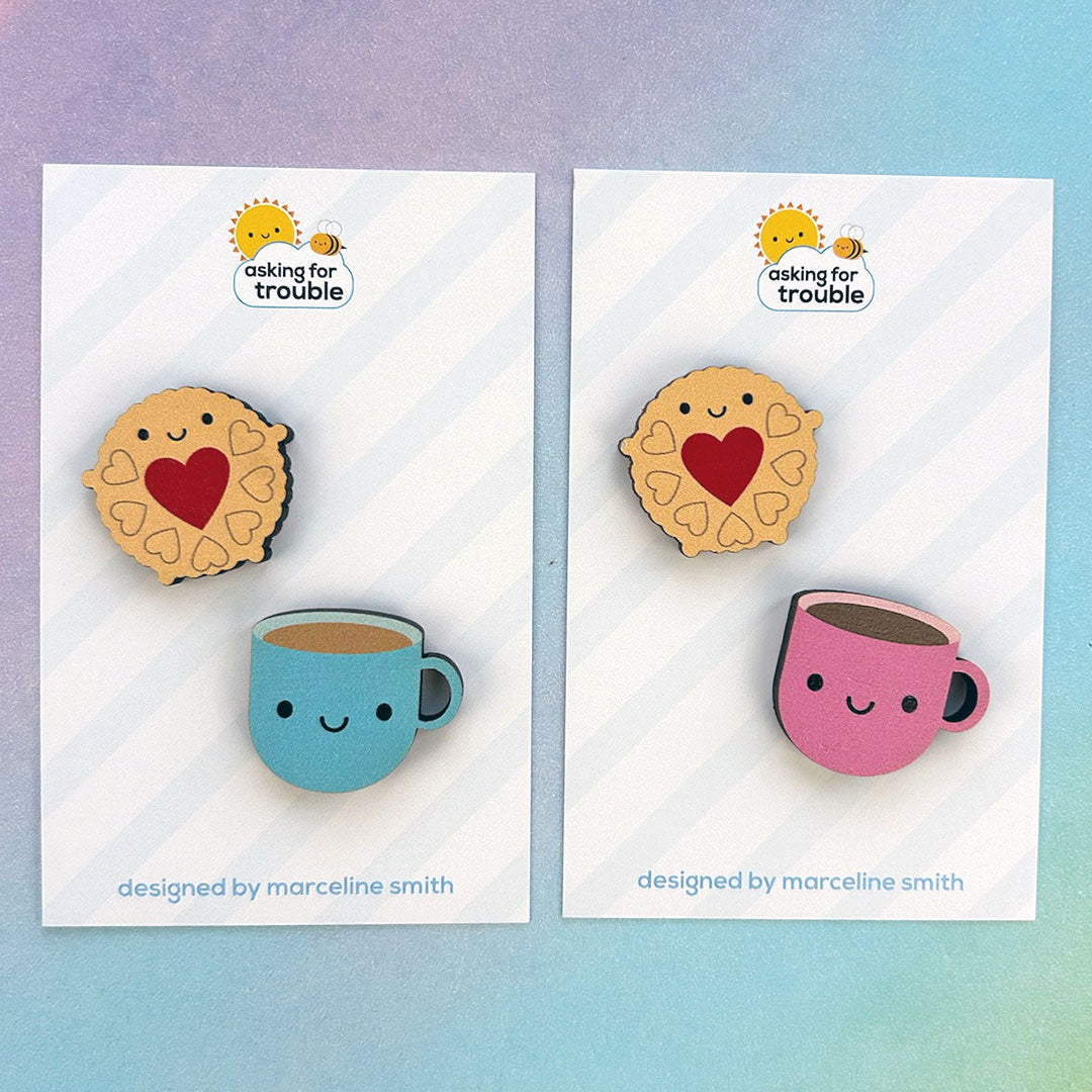 Brooches/pins are packaged on an illustrated backing card