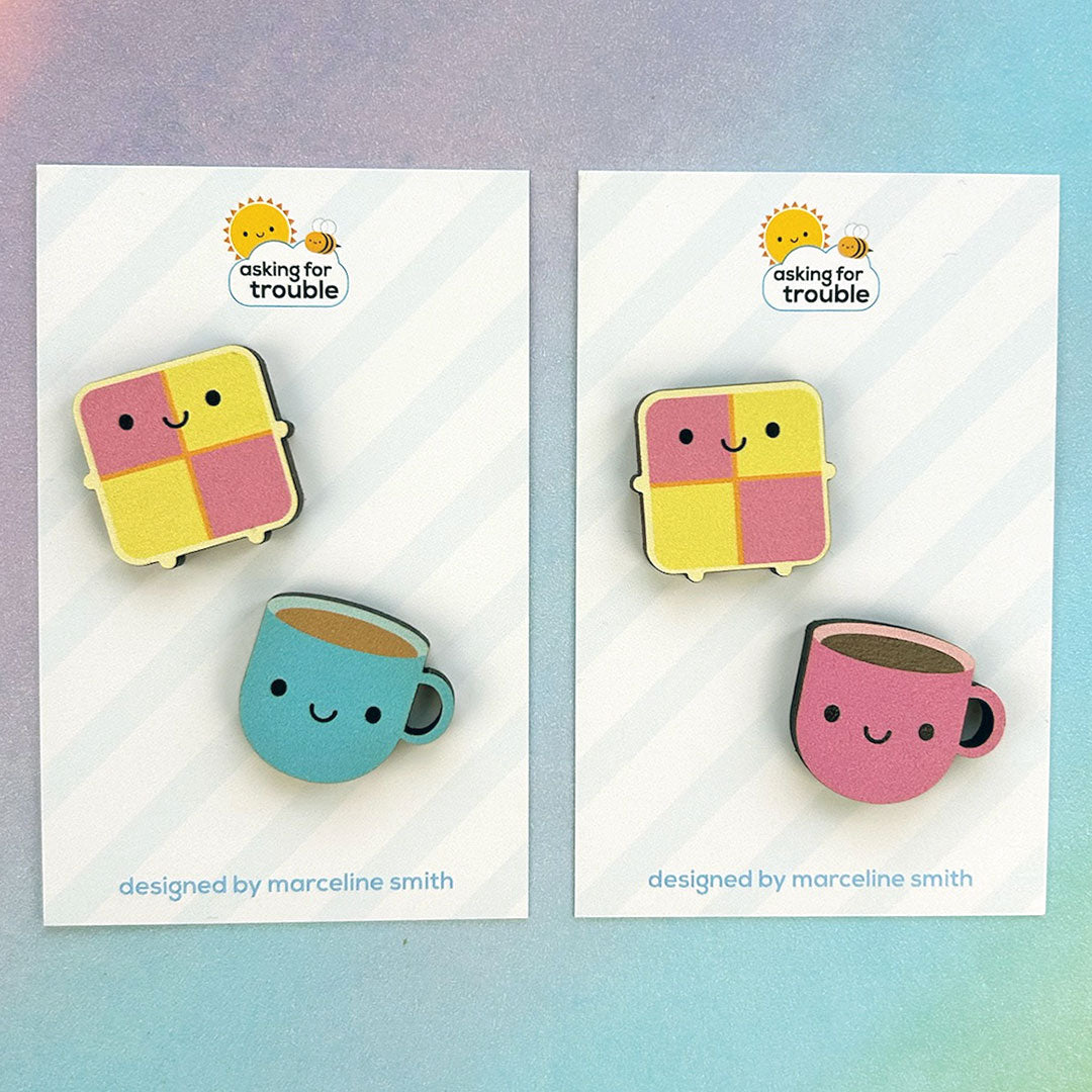 Brooches/pins are packaged on an illustrated backing card