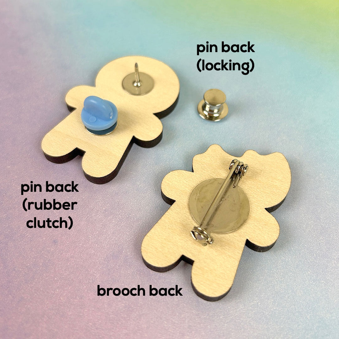 Examples of a brooch back, pin back, rubber clutch and locking back