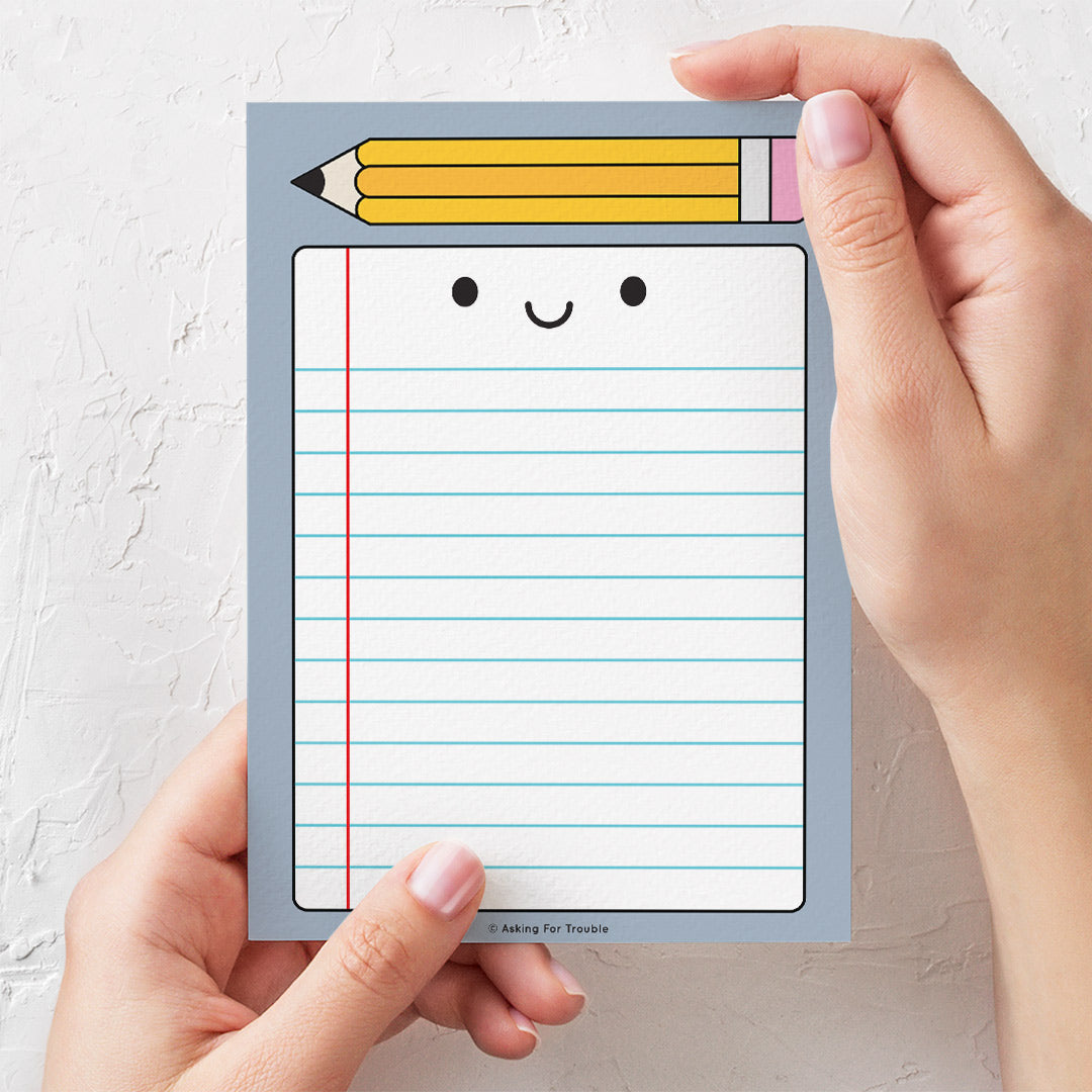 Mockup image with hands to show scale of notepad (A6 size)