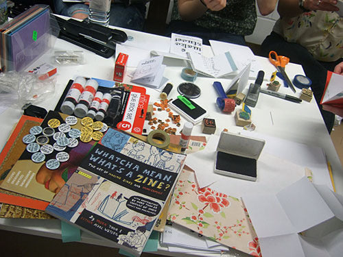 A table full of zines and craft supplies from the original zine workshop in Glasgow