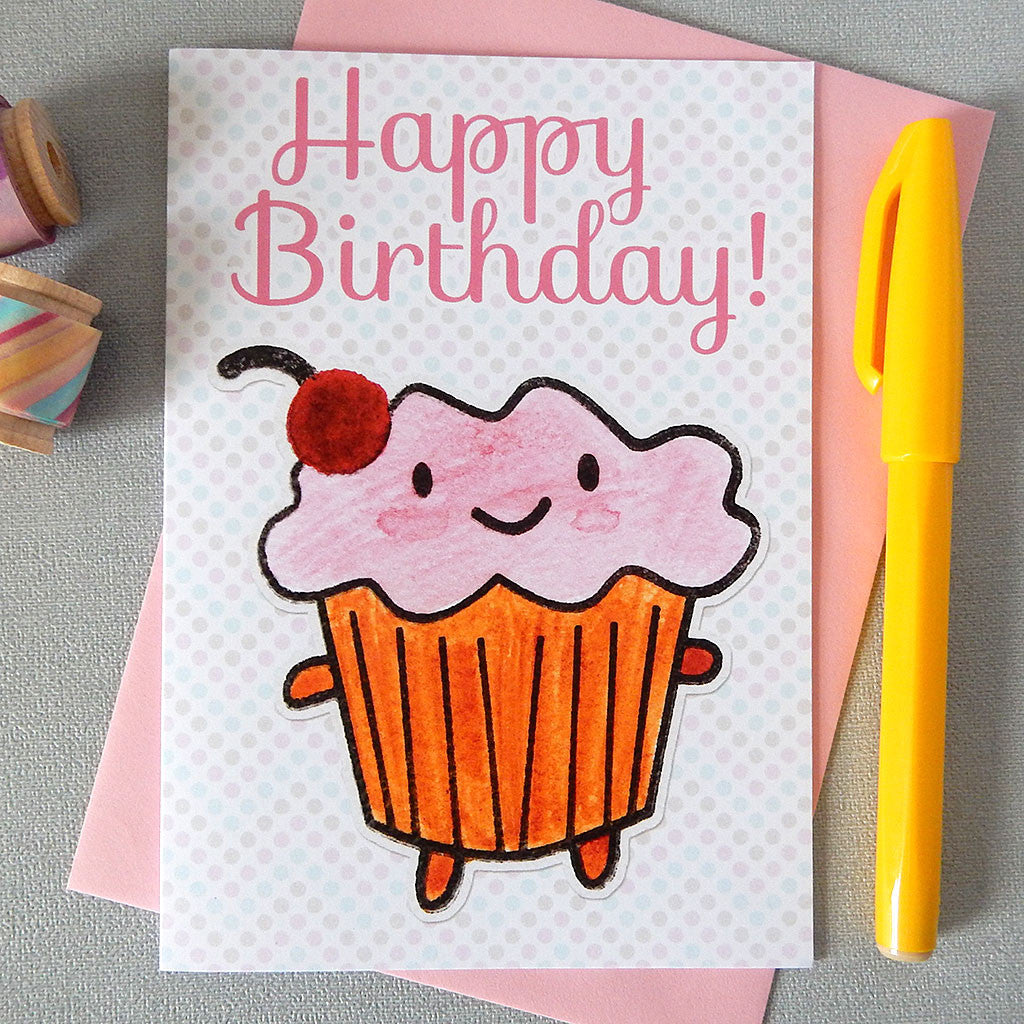 An illustrated card with a happy cupcake, the words 'happy birthday!' and a polka dot background