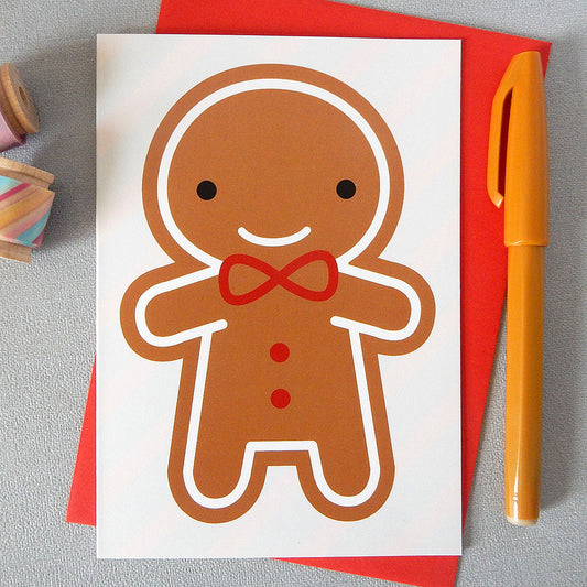 An illustrated card with a happy gingerbread man