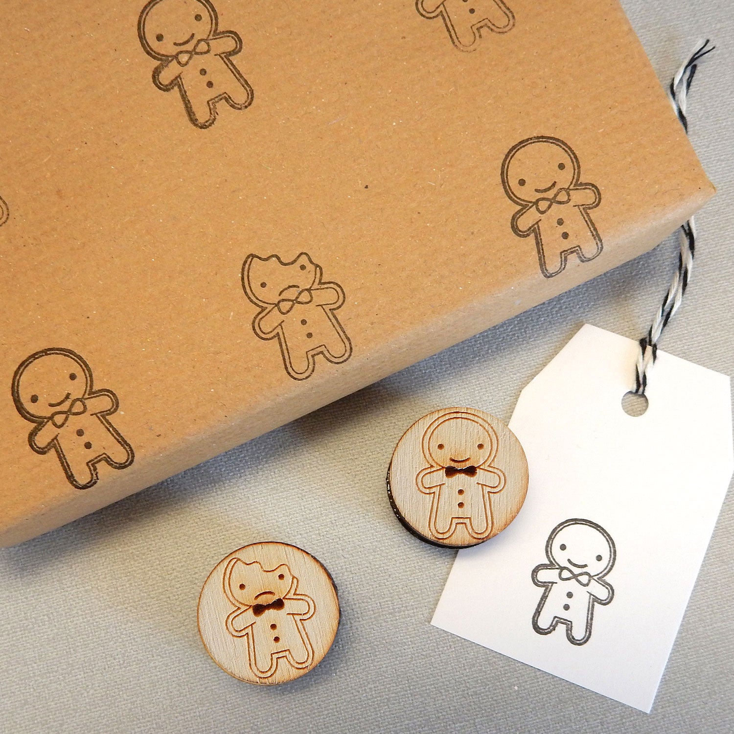 A parcel wrapped in brown kraft paper that has been stamped with a pattern of gingerbread men