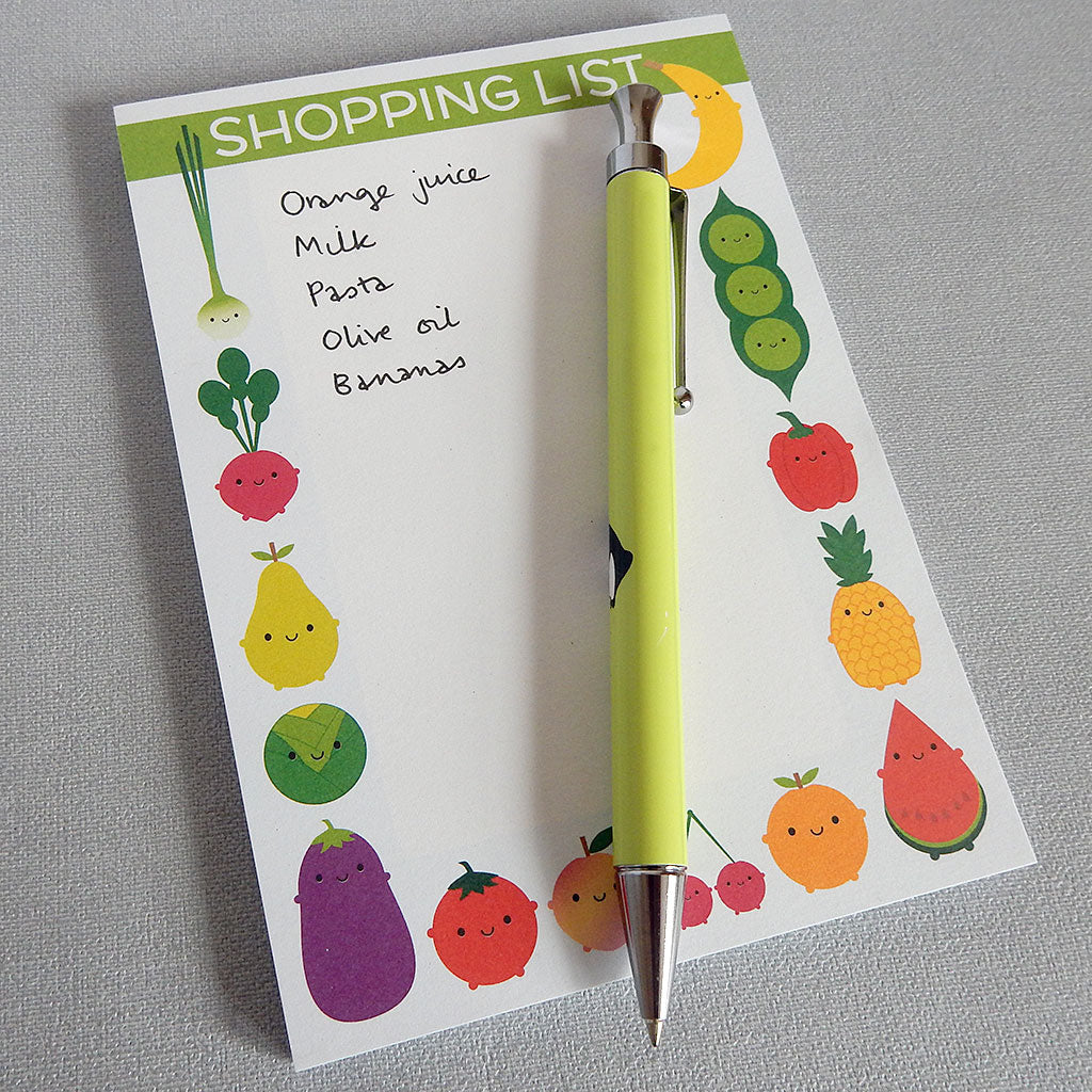 Example of shopping list notepad in use with hand-written notes and pen for scale