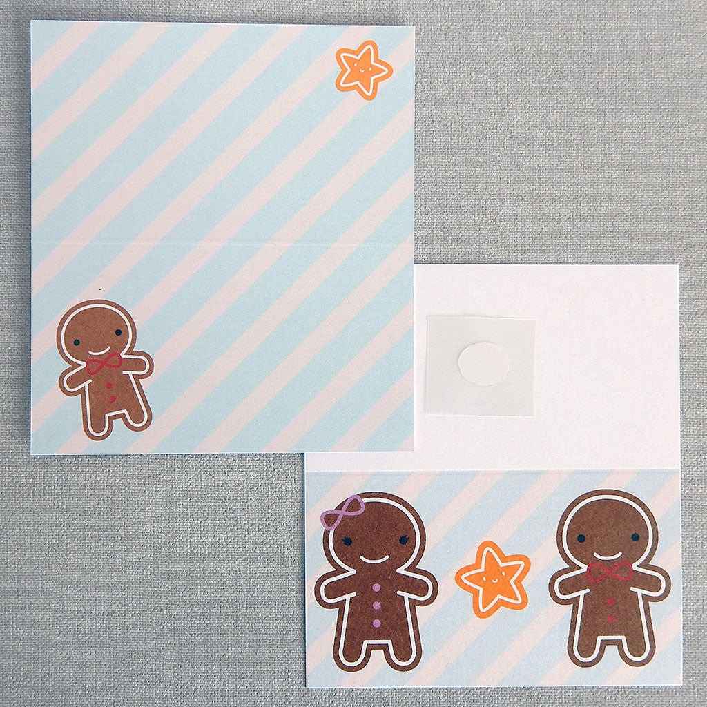 Two Cookie Cute gift tags showing the front and inside illustrations of happy gingerbread men