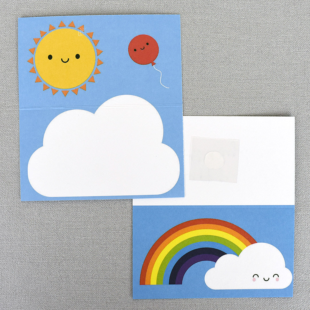 Two Kawaii Skies gift tags showing the front and inside illustrations of happy rainbow, clouds, sun and balloon