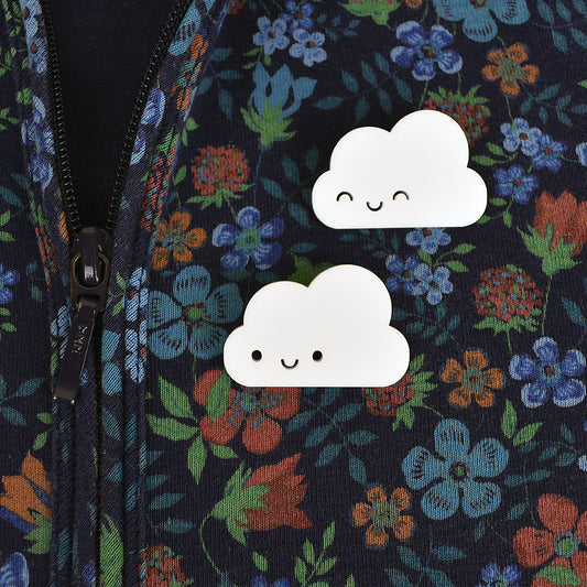 2 kawaii cloud acrylic brooches pinned to floral hoodie
