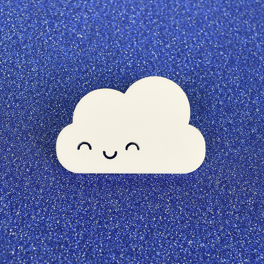 A kawaii Happy Cloud brooch laser cut from white acrylic (with closed eyes)