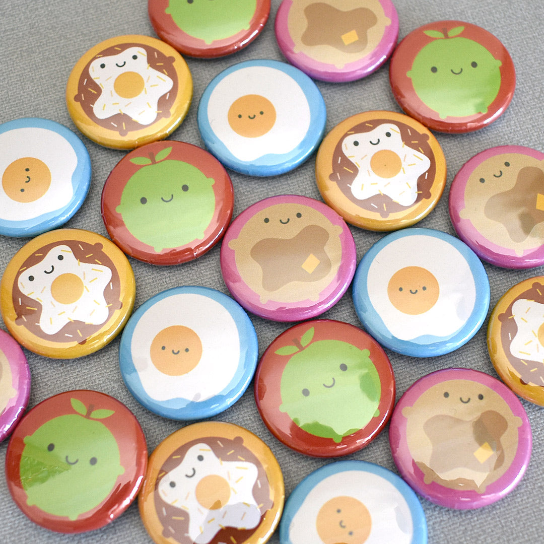 A mix of the finished Kawaii Breakfast badges laid out together